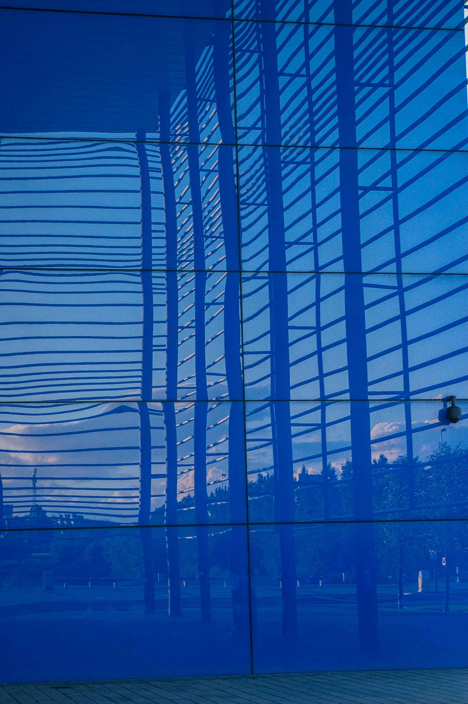Blue mirrored glass reflecting Granton gasworks and surrounding structures