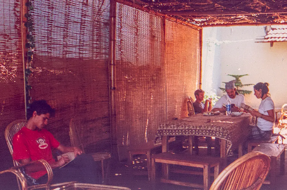 Travellers sitting together in a shaded cafe